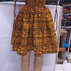 Store A vibrant African print (Ankara) dress featuring a bold mustard-yellow and black abstract tribal pattern.