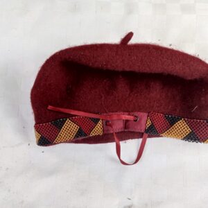 Handmade wool felt beret with a bold Maasai-inspired beaded trim in red, black, and gold. A warm, tribal-chic accessory with an adjustable fit — perfect for adding cultural flair to any outfit.